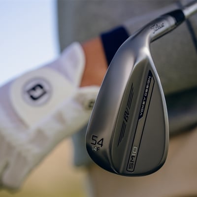 Golfer holding a 54F Vokey wedge
