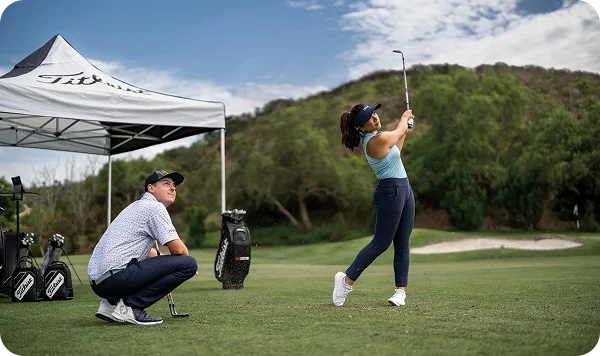 A golfer in a swing stance on the course.