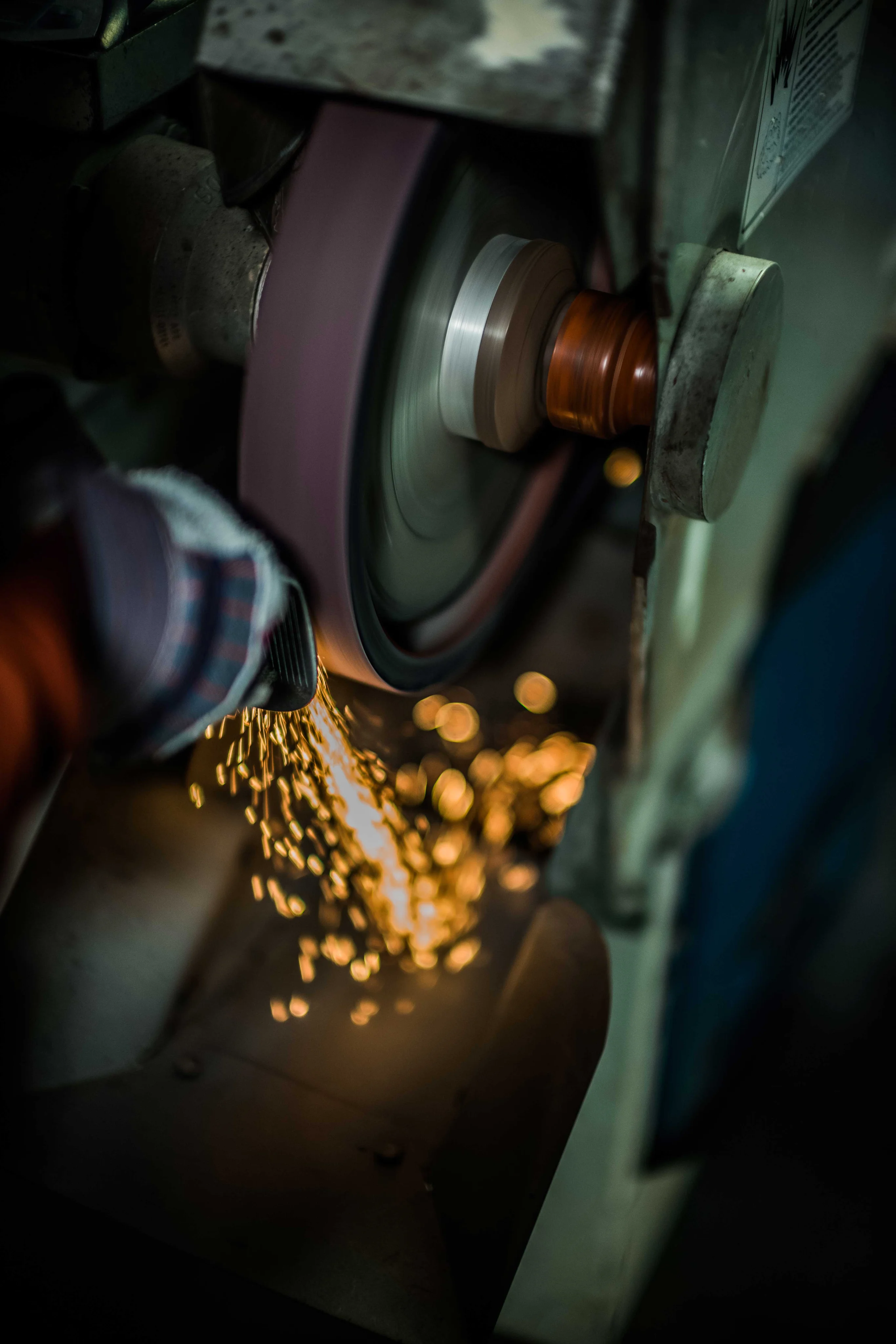 Action shot of custom hand grinding in Bob's workshop.